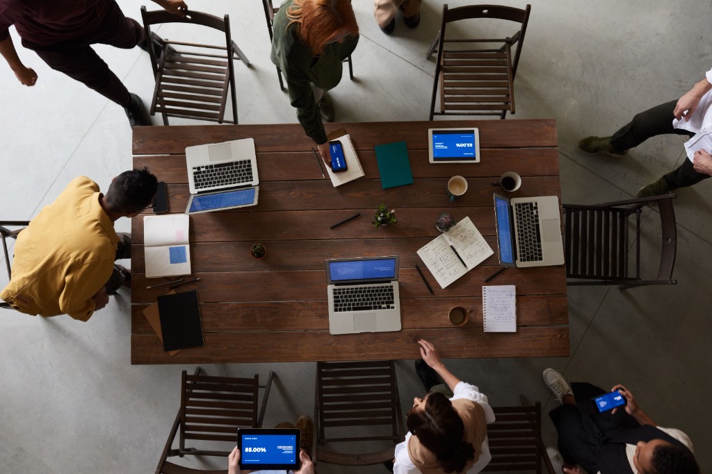 Technology professionals collaborating around a shared workspace